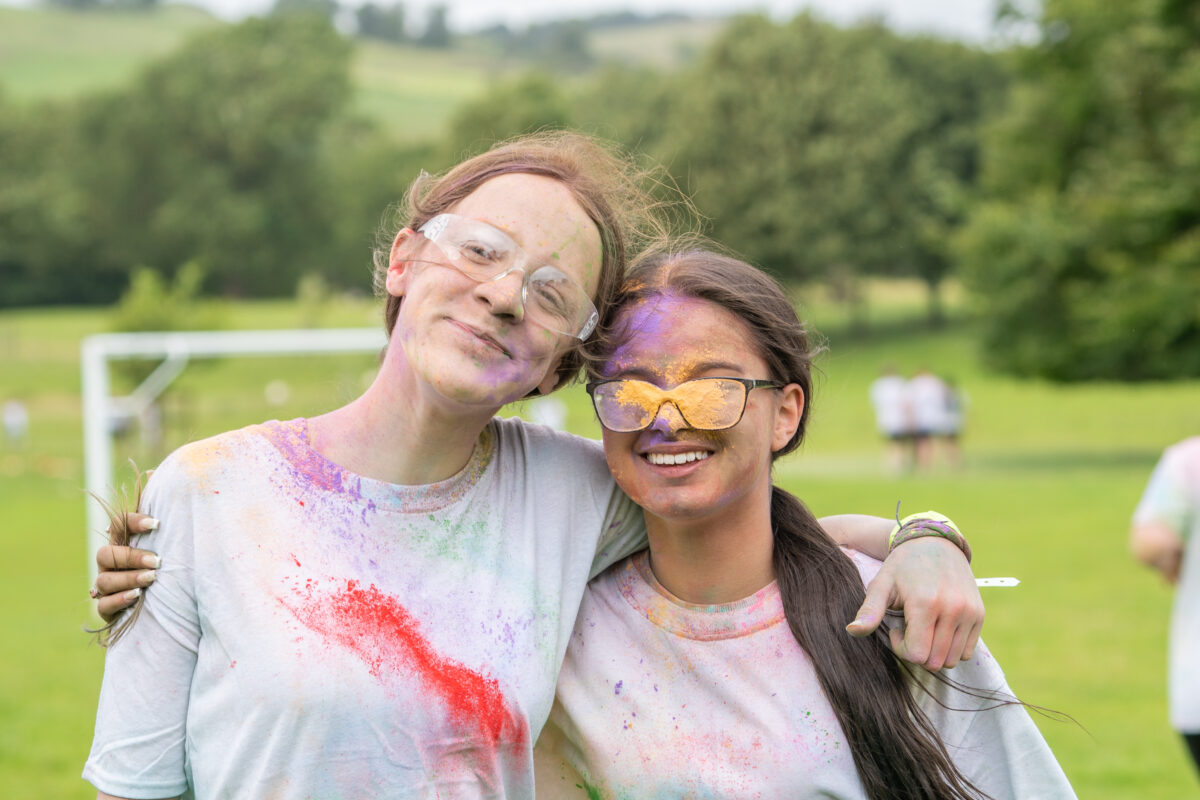 Two people with paint on their clothes