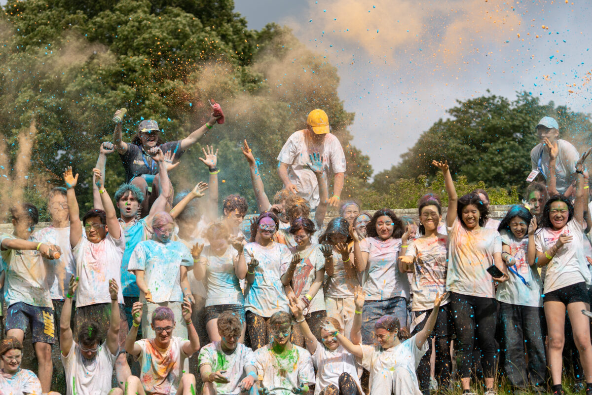 Group of people with lots of paint flying around