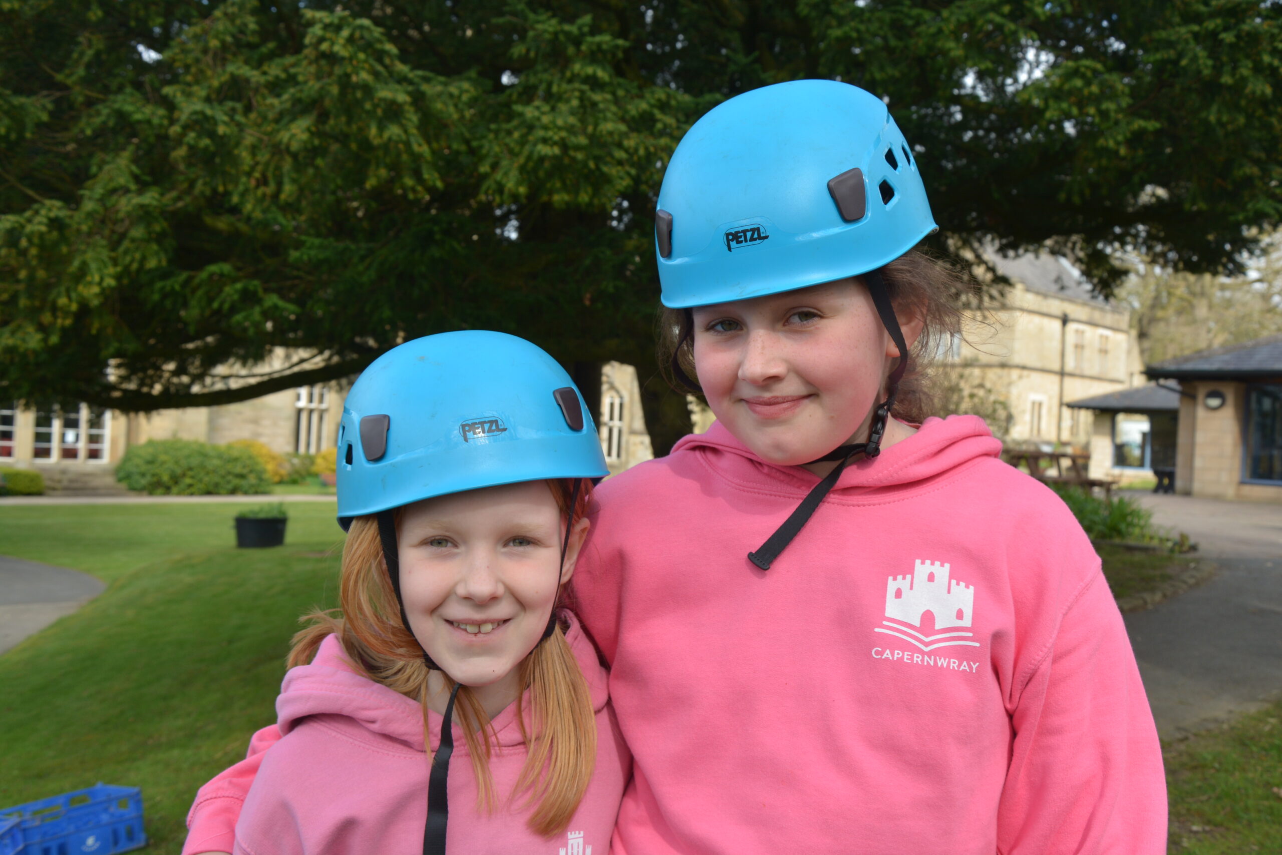 Two girls wearing hard hats